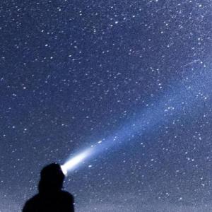 A person looking at the night sky. 